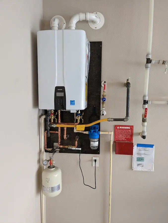 Professional plumber installing copper piping in a Muscatine home